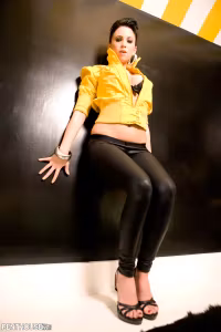 Chloe J literally peels herself, like a banana, out of her retro 90s bright neon yellow jacket...